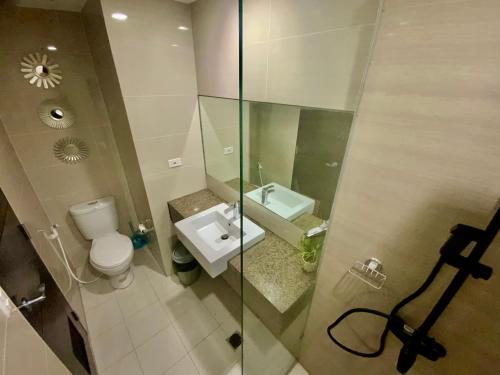 a small bathroom with a toilet and a sink at The Haven at One Eastwood Tower 1 in Manila