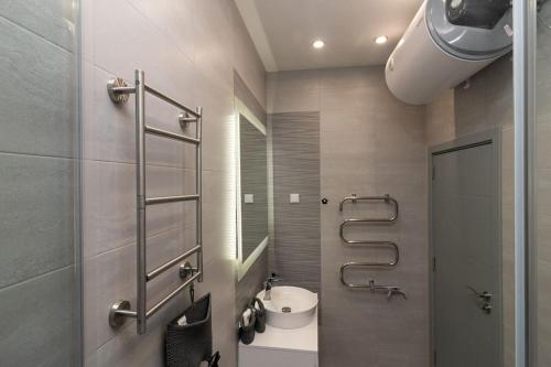 a bathroom with a sink and a mirror at Unique Central 1 Bedroom Flat in Sofia