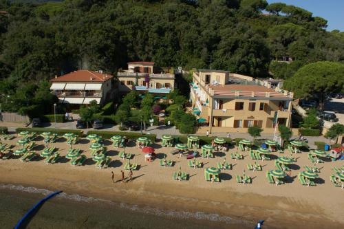 an aerial view of a beach with chairs and umbrellas at Residence Le Acacie in Capoliveri