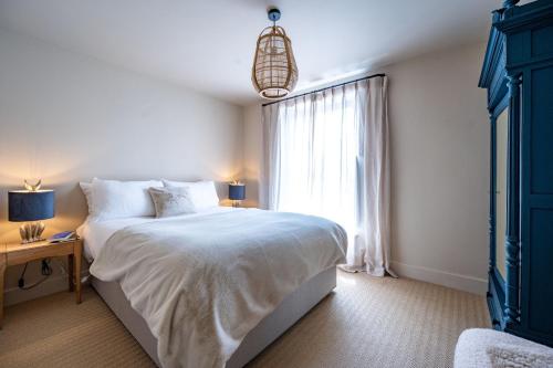 a bedroom with a large bed and a window at Number 27 by Big Skies Cottages in Holt