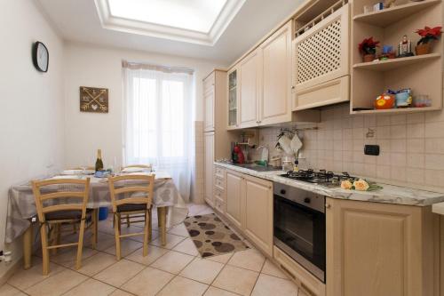 a kitchen with a table and a stove top oven at Anzio- central holiday house. in Anzio