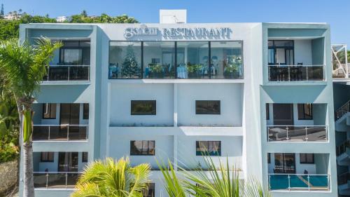 an apartment building with a sign that reads swift apartmentmaximum at Skylight Suites Hotel in San Felipe de Puerto Plata