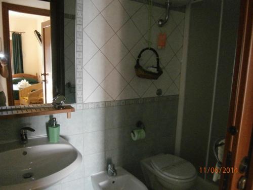 a bathroom with a sink and a toilet and a mirror at B&B Casa Mila' in Pretoro