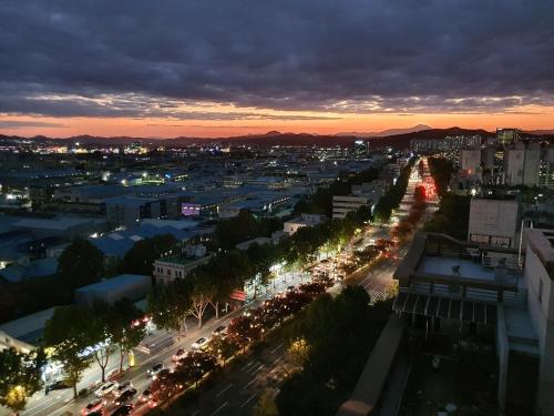 a view of a city at night at Cozy House in Daegu