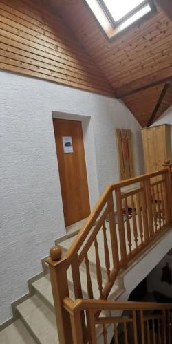 a wooden staircase in a house with a skylight at lovely apartment in Oberpilsbach