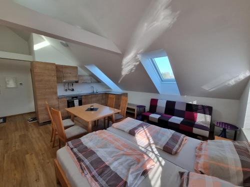 a bedroom with a bed and a table and a kitchen at lovely apartment 