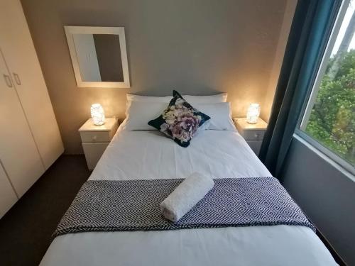 a bedroom with a bed with a pillow and a window at 125 Laguna La Crete, Uvongo in Margate