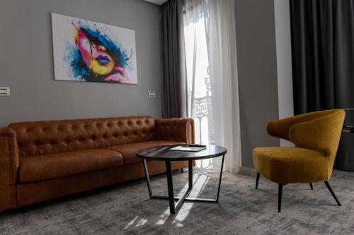 a living room with a couch and a table and a chair at H41 Luxury Suites in Belgrade