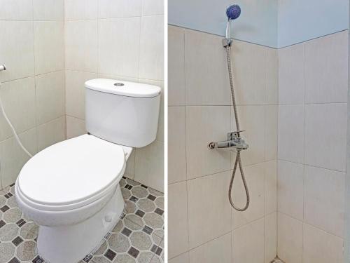 a bathroom with a toilet and a shower at SPOT ON 1711 Serayu Sumbersari Residence in Malang