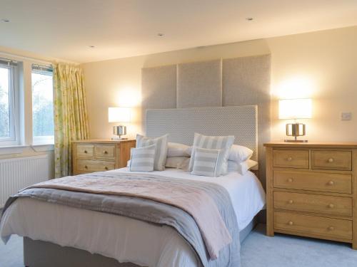 a bedroom with a bed with two dressers and two lamps at Whitehouse Studio in Roslin