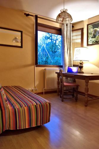 a living room with a desk and a table with a chair at Maison à la campagne entre Nancy et Pont-à-Mousson in Malleloy
