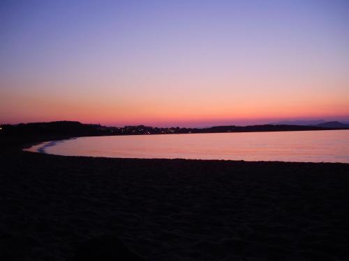 a sunset over a body of water at Melani Apartments in Chania