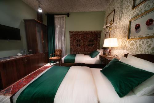 a hotel room with two beds and a television at Ati Ambavi Botique Hotel Gudauri in Gudauri