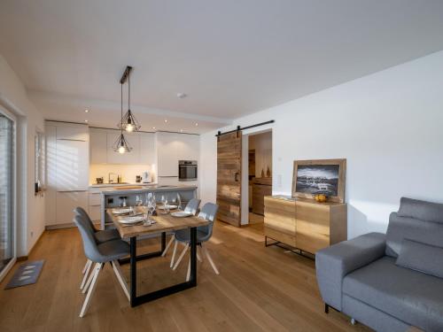 a kitchen and living room with a table and a couch at Ferienwohnung Tirolglück mit großem Garten in Sankt Johann in Tirol