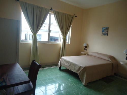 Postel nebo postele na pokoji v ubytování Hotel Suites Córdoba