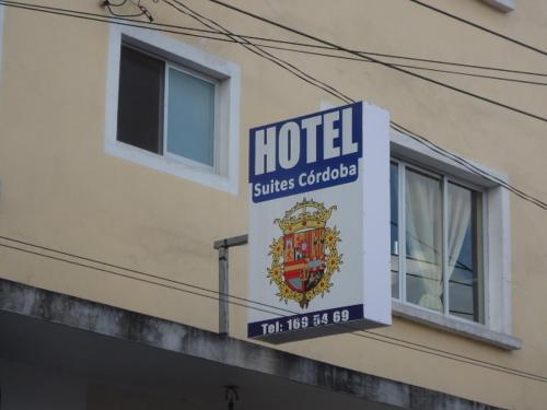 a sign for a hotel on the side of a building at Hotel Suites Córdoba in Córdoba