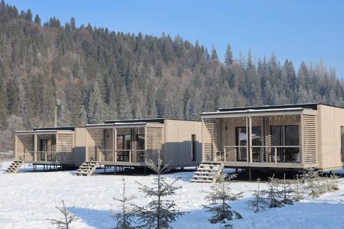 a row of modular homes in the snow at River Cottage Complex in Richka