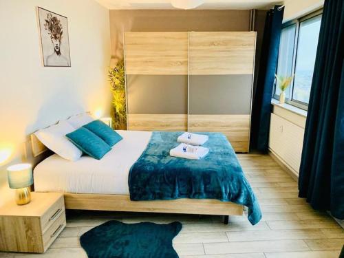 a bedroom with a bed with two towels on it at TOUR de l’europe, en plein centre avec parking. in Mulhouse