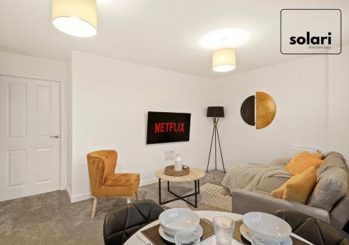 a living room with a couch and a table at Lavish 2-Bedrooms - Contractors and Relocators Apartment, 30-Percent-Off on Monthly Stays - Free Multiple Parking Spaces - Guest 4 - Fast Speed Wi-Fi, Streaming Services included - Close to A1 in Peterborough