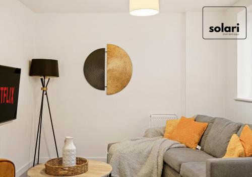 a living room with a couch and a table at Lavish 2-Bedrooms - Contractors and Relocators Apartment, 30-Percent-Off on Monthly Stays - Free Multiple Parking Spaces - Guest 4 - Fast Speed Wi-Fi, Streaming Services included - Close to A1 in Peterborough