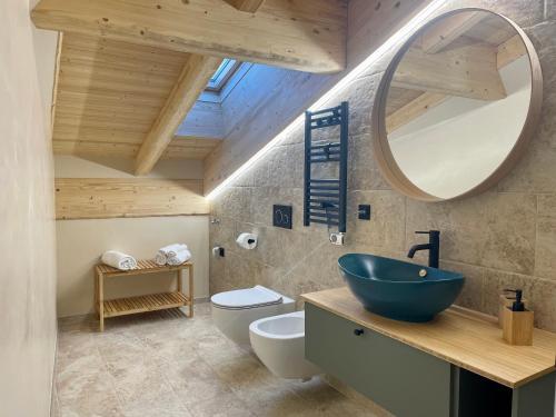a bathroom with a blue sink and a mirror at La casina di Vigo in Ton