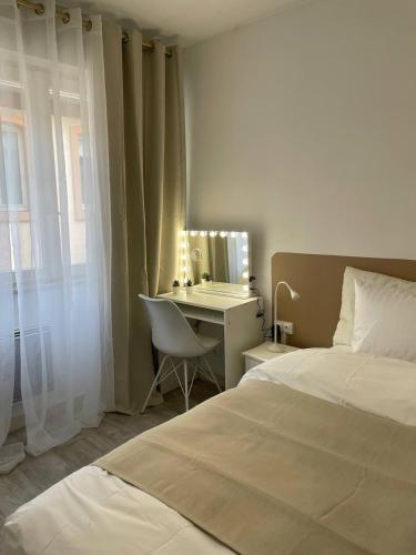 - une chambre avec un lit et un bureau avec un miroir dans l'établissement Cozy Appartement Halles Strasbourg, à Strasbourg
