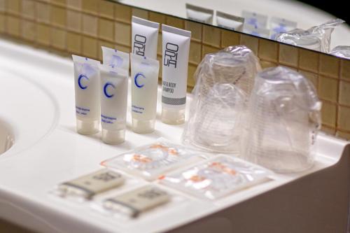 a bathroom counter with toothbrushes and other items on it at Rija Bauska Hotel in Bauska