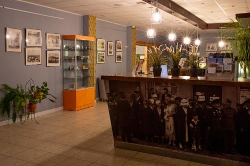 a room with a counter with photos on the wall at Rija Bauska Hotel in Bauska