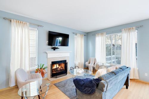 a living room with a couch and a fireplace at The Place To Be; With A Hot Tub! in Clackamas