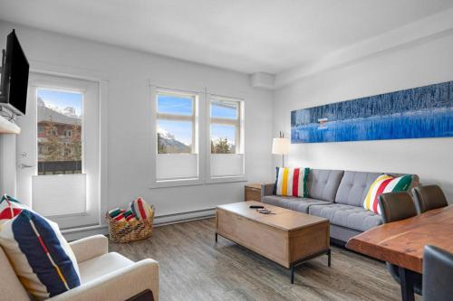 a living room with a couch and a table at Beautiful Renovated Wolf 2Bed 2Bath in Canmore