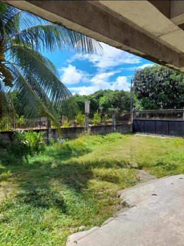 a view from under a bridge of a grass field at DUMAHOSTEL in Daro