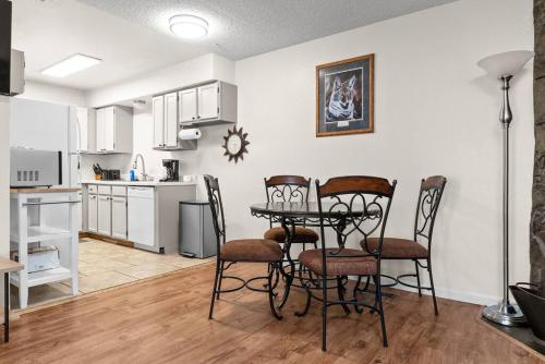 a kitchen and dining room with a table and chairs at Alaskan WolfDen Close to airport centrally located in Anchorage