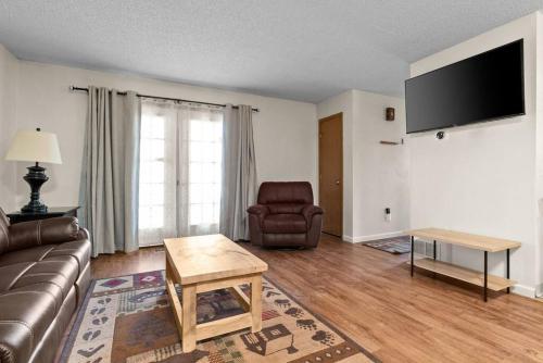 a living room with a couch and a chair at Alaskan WolfDen Close to airport centrally located in Anchorage