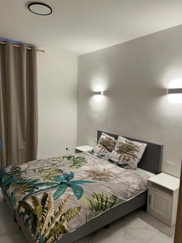 a bedroom with a large bed with a night stand at Riverbank Guest House in Namur