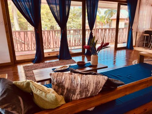 a living room with a bed and a balcony at Casa Le Parc - Main Street in Bocas Town
