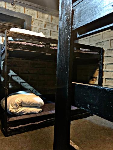 two bunk beds in a room with a brick wall at Khwaab in Munsyari