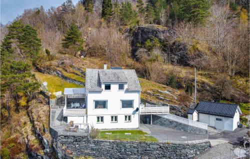 an aerial view of a white house on a hill at 5 Bedroom Amazing Home In Strandebarm in Strandebarm