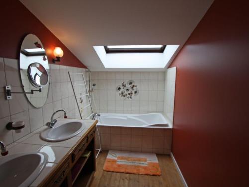 a bathroom with two sinks and a bath tub at Gîte de Charme avec Terrasse près de Bourbonne-les-Bains, 2 chambres, poêle à bois, Wifi inclus - FR-1-589-118 in Lironcourt