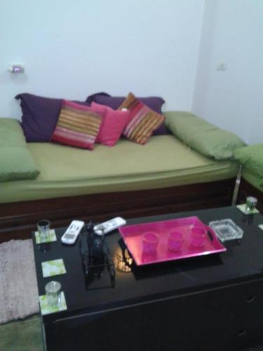 a living room with a couch and a table with a tray at Villa Carimo in Quseir