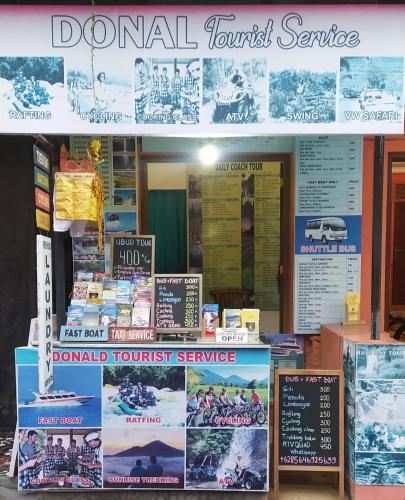 a book store with signs in front of it at Donald Home Stay in Ubud