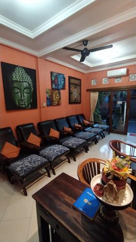 a living room with couches and a table at Donald Home Stay in Ubud