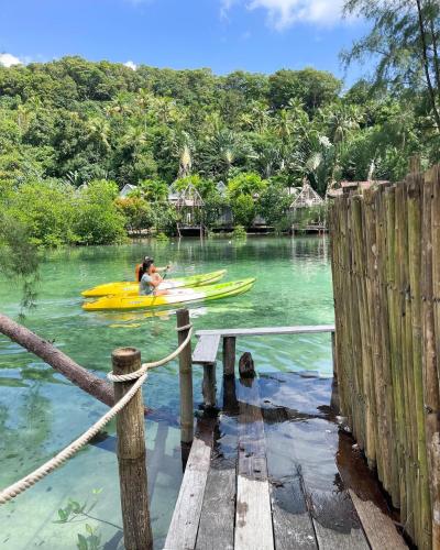 a person in a kayak on a dock in the water at À La Koh Kood Resort in Ko Kood
