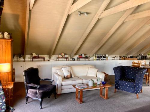a living room with a couch and two chairs at Elevation652 at Mt Bellevue in King Valley in Myrrhee