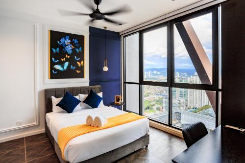 een slaapkamer met een bed met blauwe muren en een groot raam bij Scarletz Suites KLCC by Mana-Mana in Kuala Lumpur