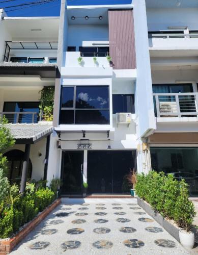 a large white building with a driveway at ฺBoxsoon nimman 5 in Chiang Mai