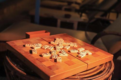 a wooden chess board with the word jihad on it at Thebes Hotel in Luxor
