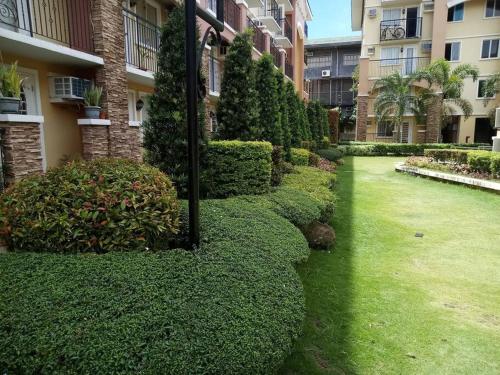 a garden in front of a building at Italian Inspired Tropical-Themed Studio Condo in Davao City