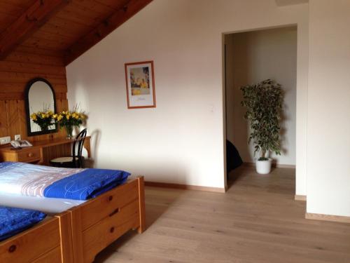a bedroom with a bed and a desk and a table at Hotel Restaurant Kulm in Triesenberg