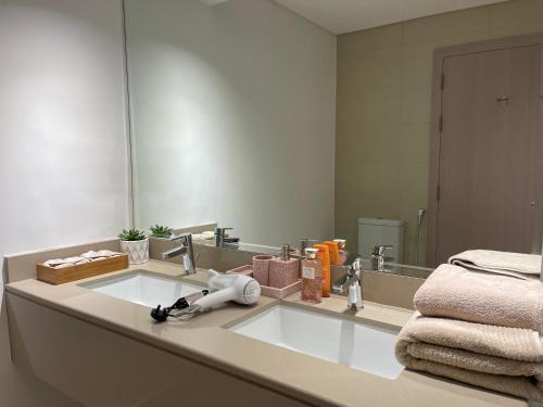 a bathroom with a sink and a mirror at Yas Island - 2 Bedrooms, 2 toilet with shared Pool & Parking in Abu Dhabi
