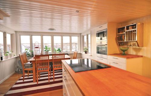 a kitchen with a table and a dining room at 2 Bedroom Stunning Home In Rönnäng in Rönnäng